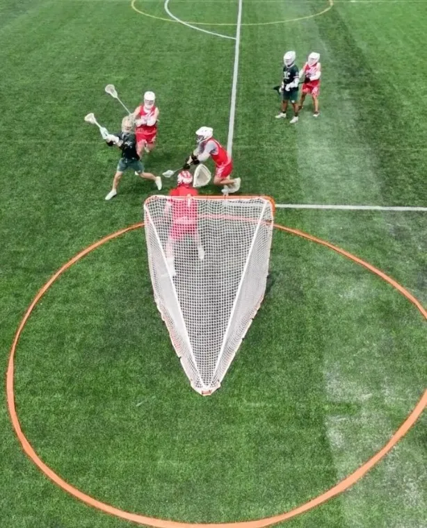 Overhead view of attackers and defenders battling in front of the goal crease